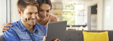 young couple looking at a tablet.