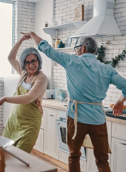 Older couple dancing in kitchen