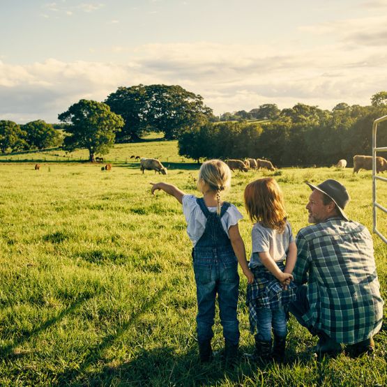 dad out on the farm with two daughters