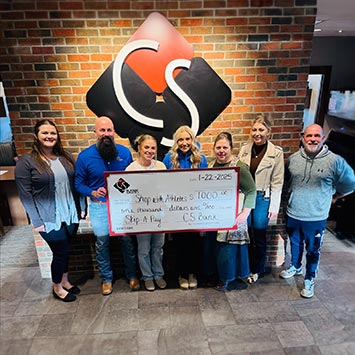 group of people and a check for best in bank harrison