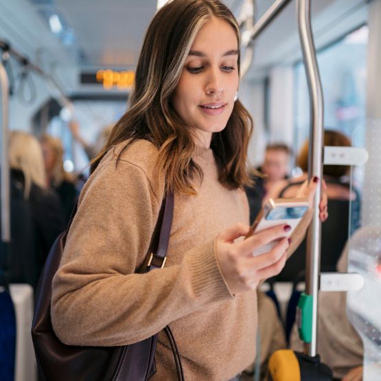 girl riding train on phone