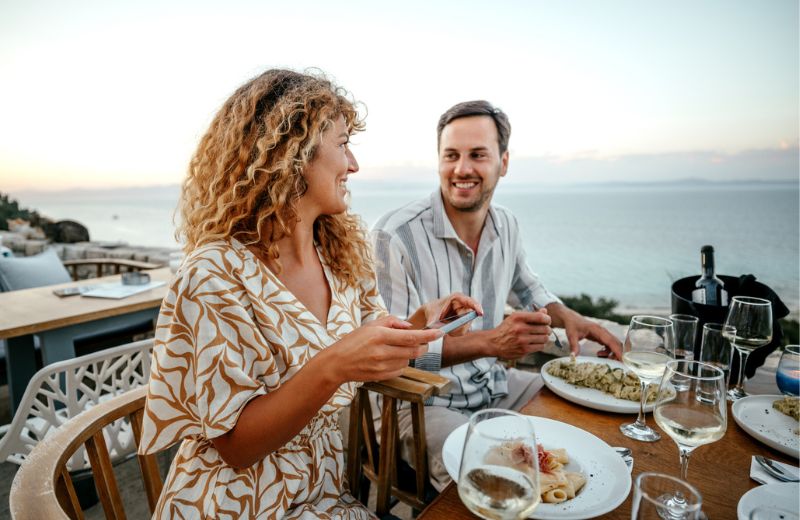 couple enjoying fancy dinner by the ocean