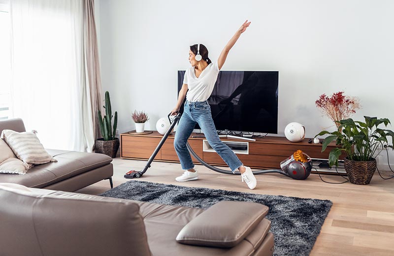 Woman vacuuming at home.