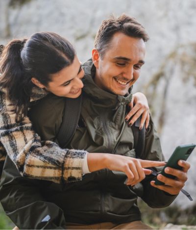 Couple hiking on phone