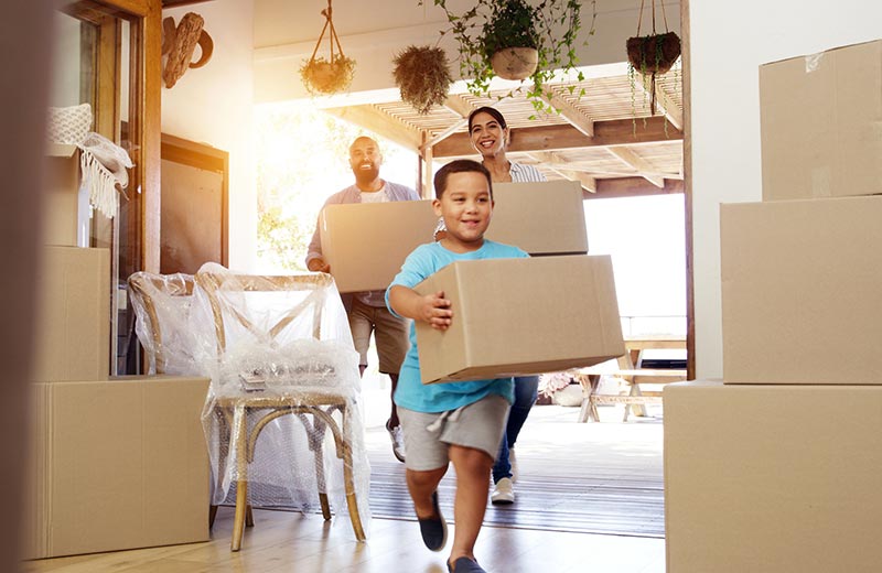 Family moving boxes into new home