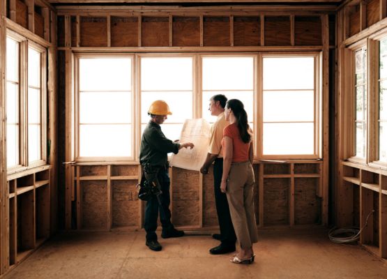 builder meeting with couple for construction build