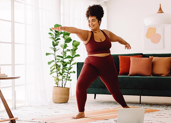 Woman doing yoga in her living room