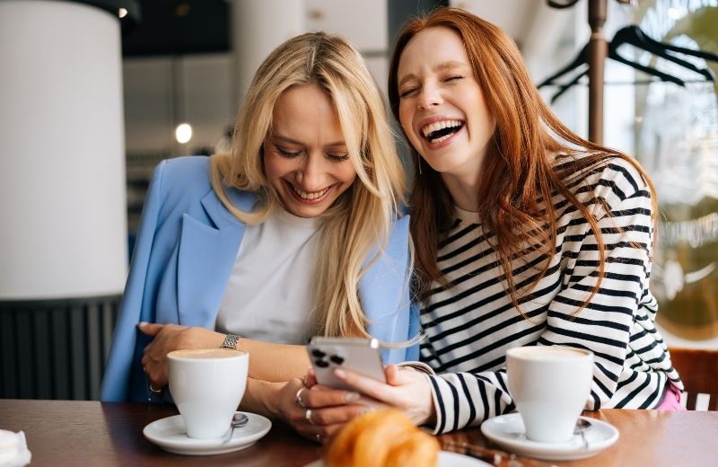 Friends enjoying a coffee - checking page