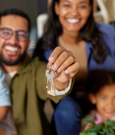 couple and family with keys to new home