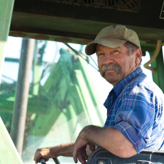 man looking over his shoulder on tractor