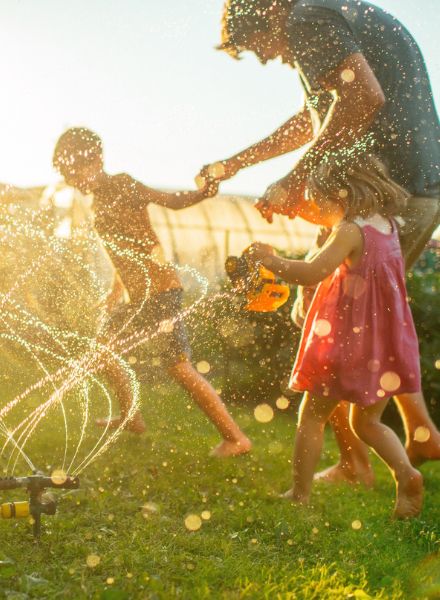 Family with young kids enjoying playing in the backyard